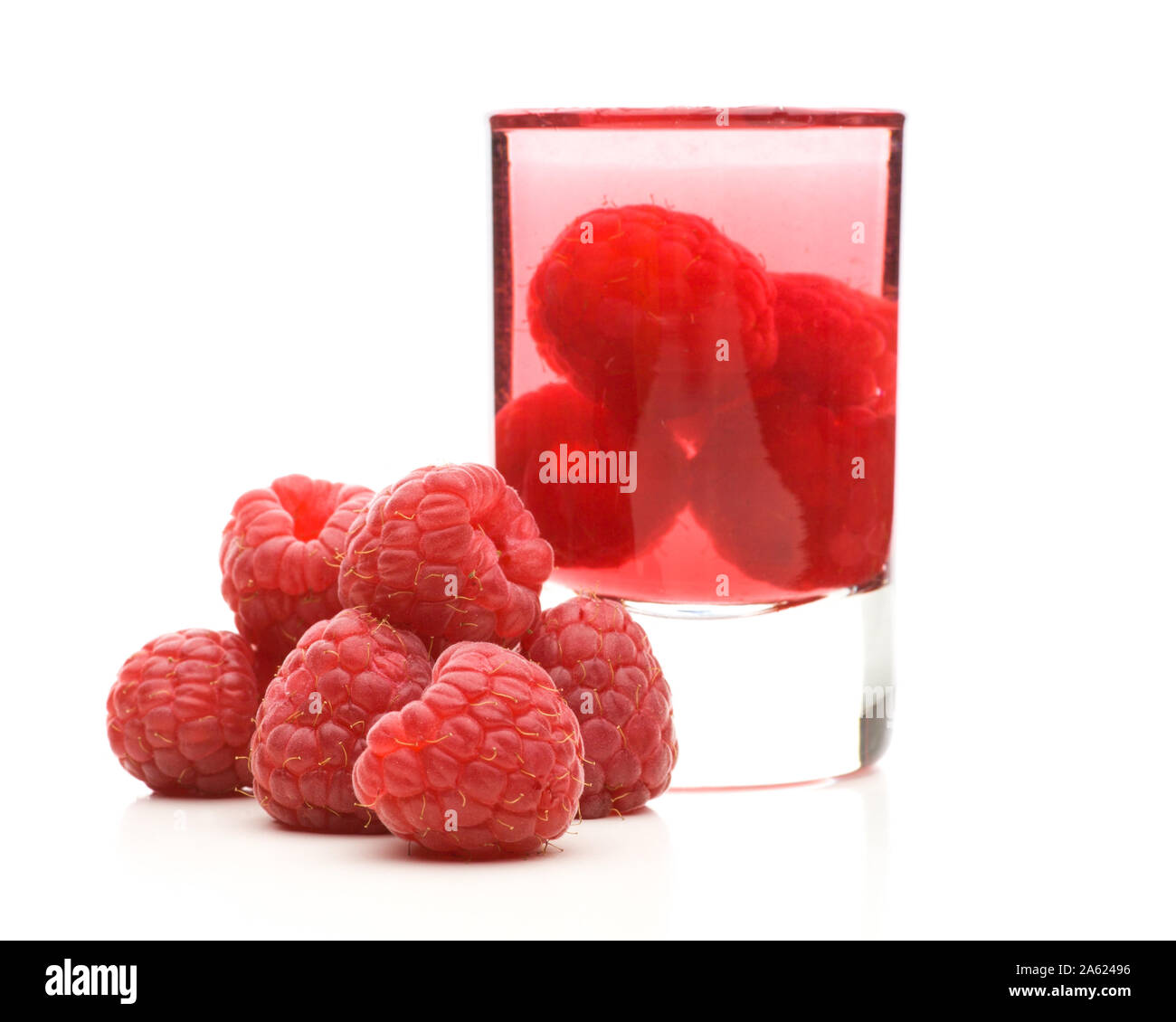 Raspberry schnapps and fresh raspberries Stock Photo