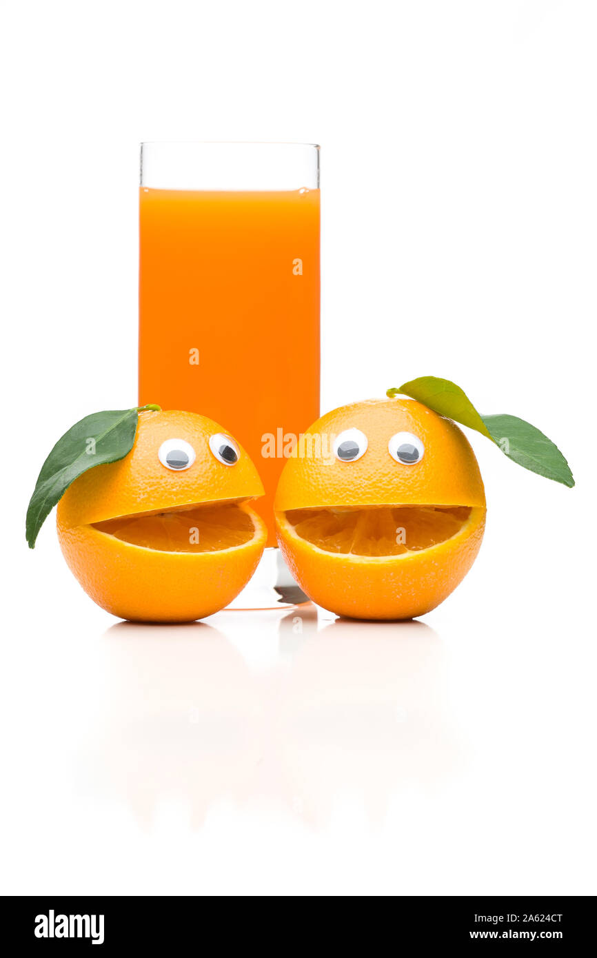 Two laughing oranges with orange juice Stock Photo
