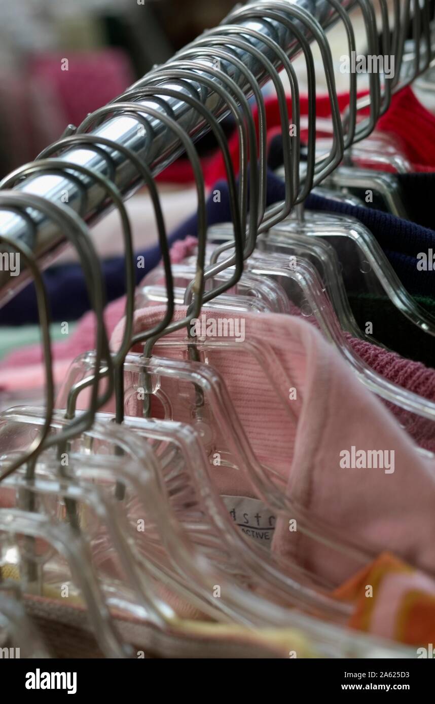 Lineup of Hangers and clothing in a boutique clothing store Stock Photo