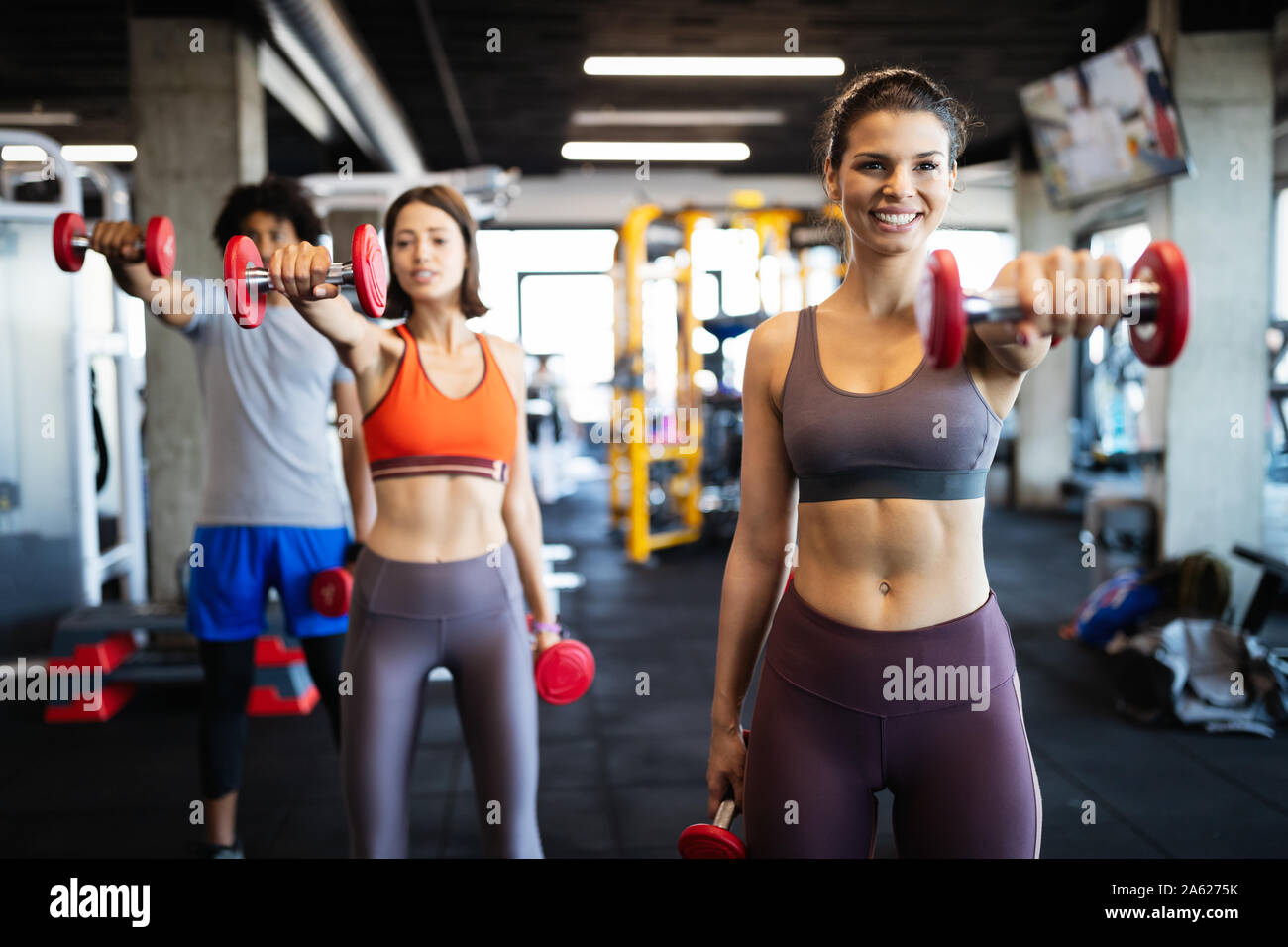 Fitness, sport, training and lifestyle concept. Group of people exercising in gym Stock Photo