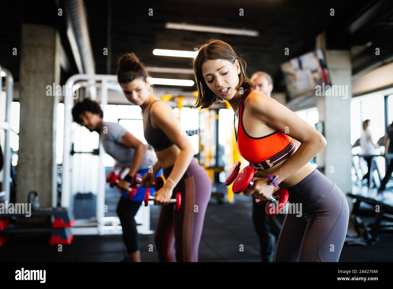 Fitness, sport, training and lifestyle concept. Group of people exercising in gym Stock Photo