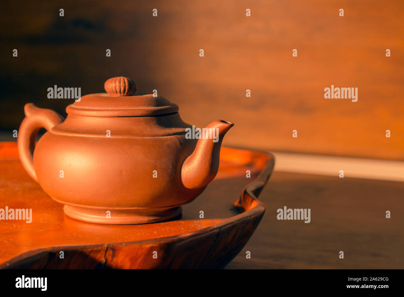Retro clay Chinese teapot on a brown background Stock Photo Alamy