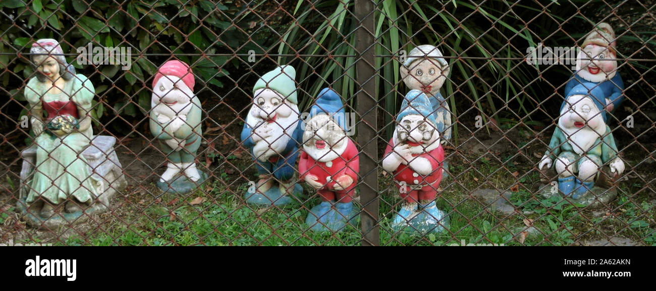 Snow white and seven dwarfs behind the  wire mesh - Brothers Grimm Stock Photo