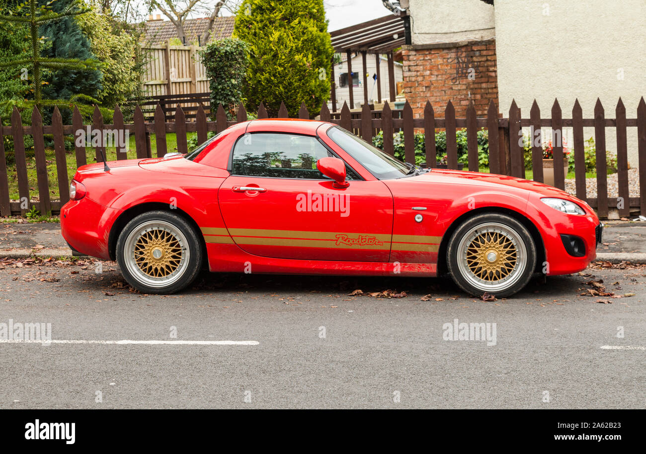 A red Mazda MX5 car parked in the village of Sadberge,England,UK Stock Photo