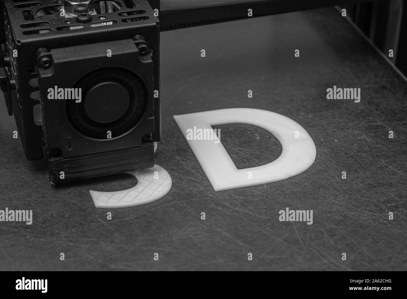 3D printer prints the word 3D with white filament PLA Stock Photo