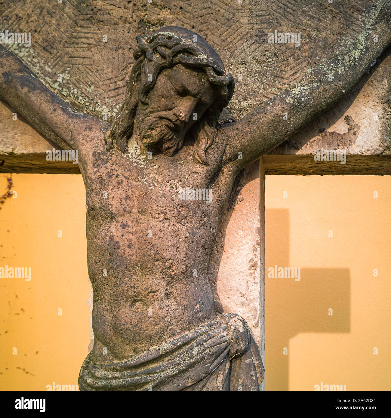 Stone crucifix and sculpture inside the churchyard of the Church Maria am Wasser (Mary By The Waters) in Hosterwitz, Dresden, Saxony, Germany. Stock Photo