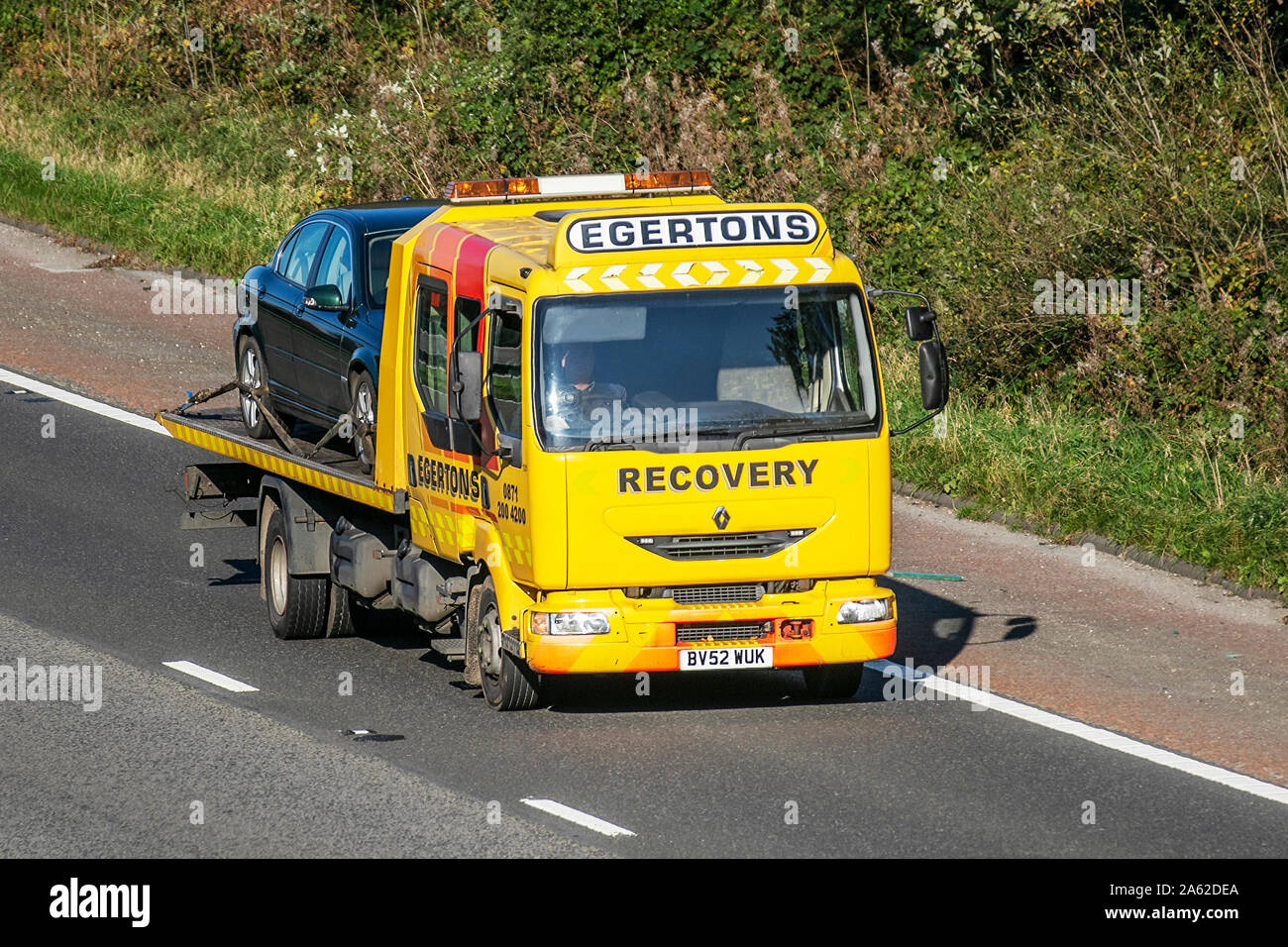 2002 Renault Midlum; Egertons Breakdon Recovery;  Haulage delivery trucks, lorry, transportation, truck, 24hr emergency rescue vehicle, delivery, commercial transport industry on the M6 at Lancaster, UK Stock Photo