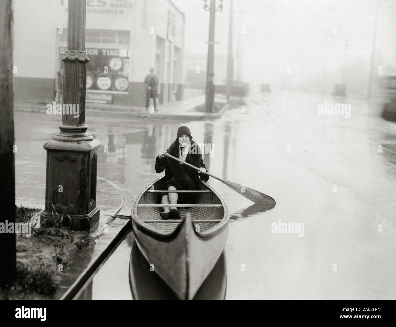 Myrna Loy on a canoe paddling through a flooded street circa 1925 File