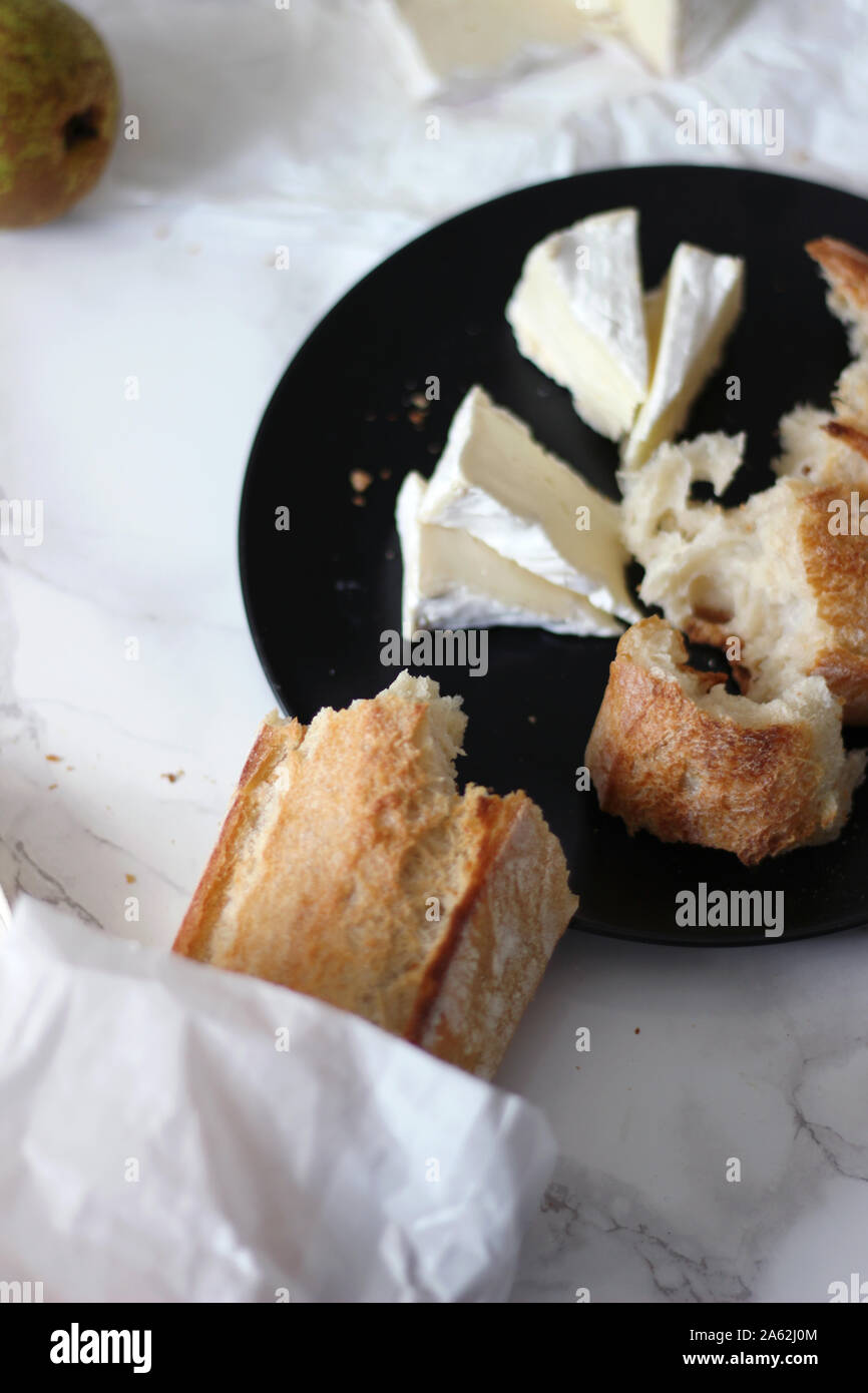 Delicious Fresh Crunchy French Baguette with Cheese Brie. Artisan Boulangerie Bread. Classic French Food in Paris. French cuisine. Stock Photo