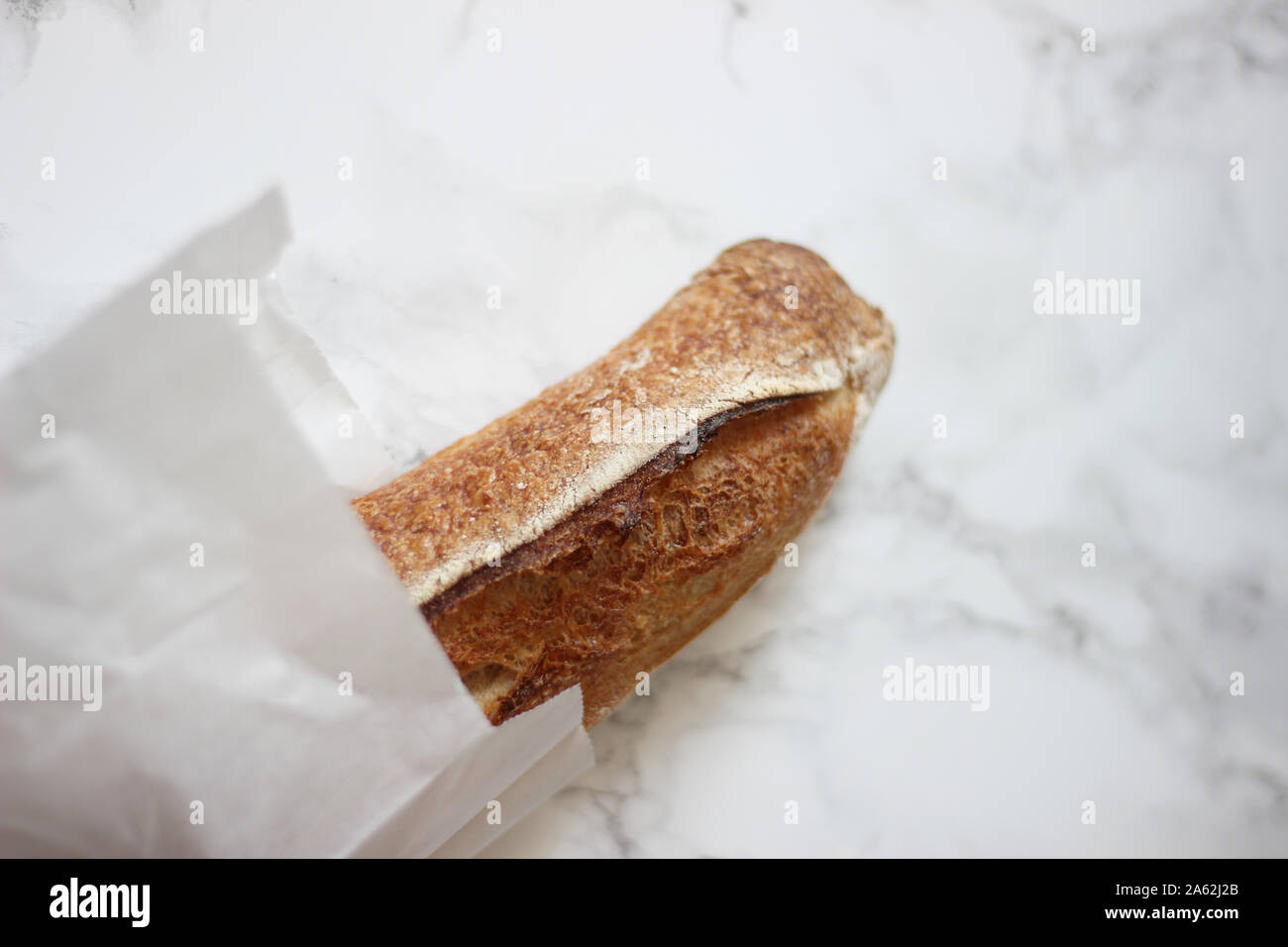 Fresh Crunchy Baguette on a table. Traditional French Bread Stock Photo ...
