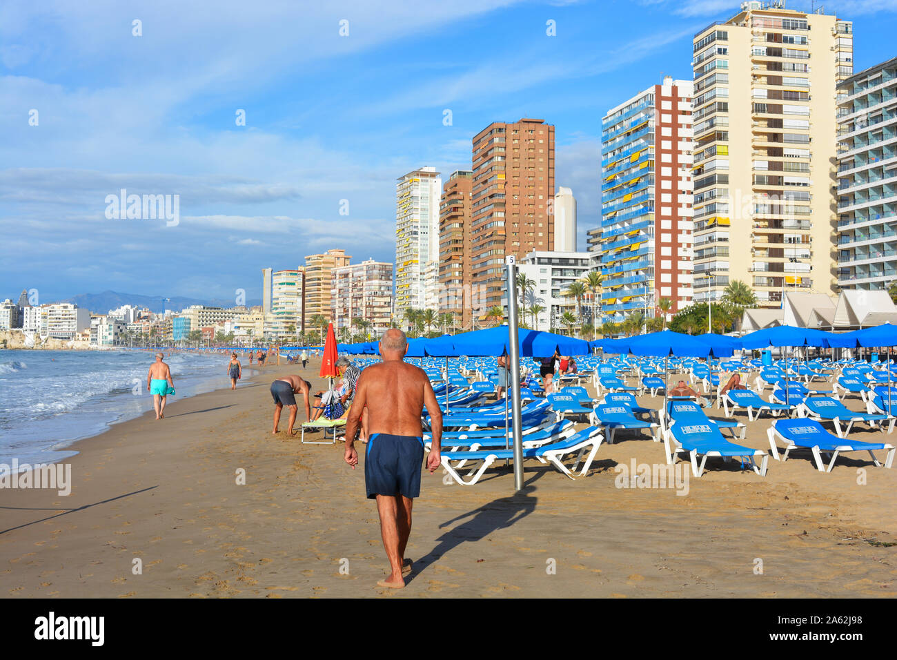 Group of active seniors on Playa Levante beach, with skyscrapers in the background, Benidorm, Alicante Province, Spain Stock Photo