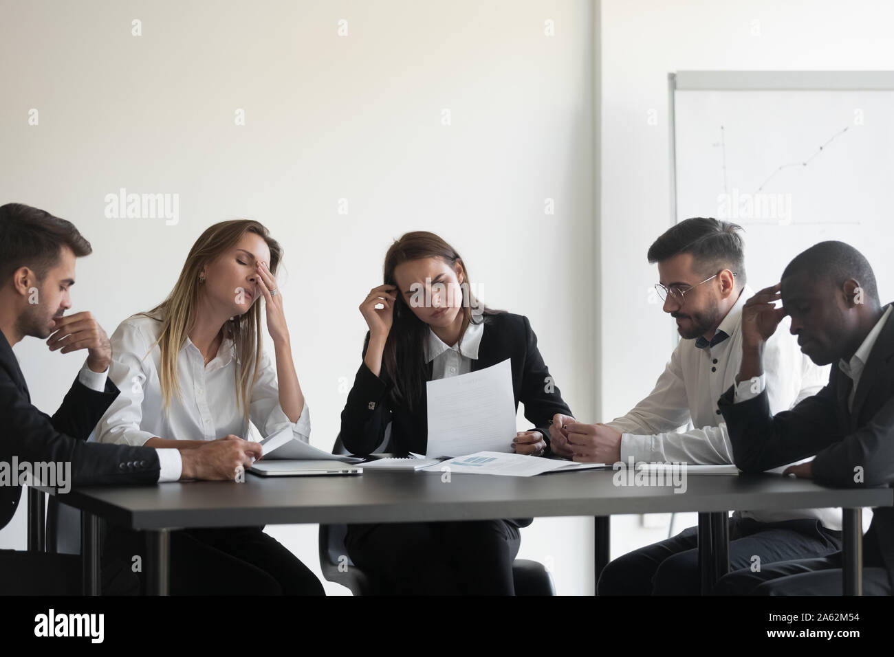 Frustrated multiracial business team people upset with corporate bankruptcy Stock Photo