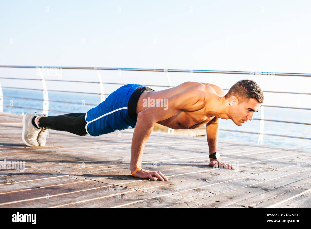 Young man fitness training outdoors Stock Photo