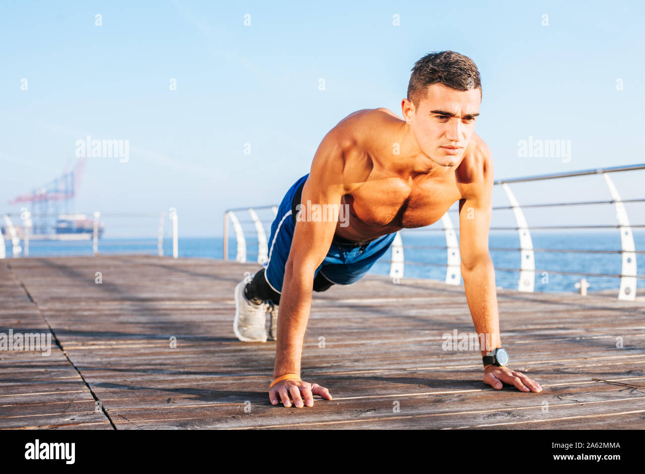 Young man fitness training outdoors Stock Photo