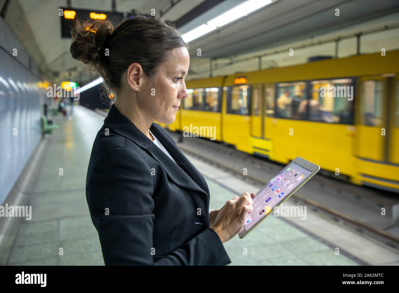 A woman works up, from the road to work, on the road, mobile, subway station, Stock Photo