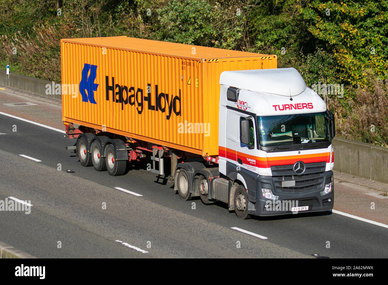 Turners Haulage delivery trucks, lorry, Hapag-Lloyd transportation, truck, cargo, Mercedes Benz vehicle, delivery, commercial transport, industry, supply chain freight, on the M6 at Lancaster, UK Stock Photo