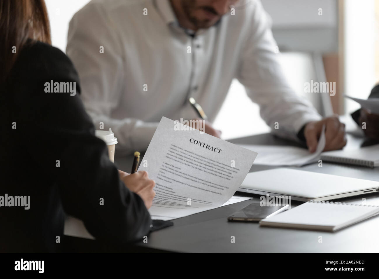 Female and male business partners sign contracts concept, closeup view ...