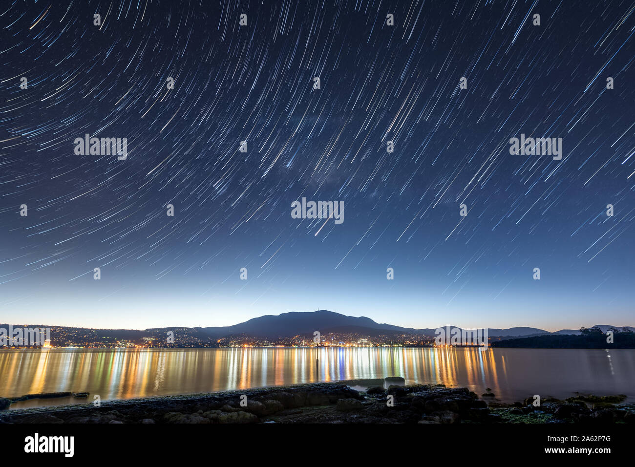 Hobart, Tasmania by night with star trail overhead Stock Photo