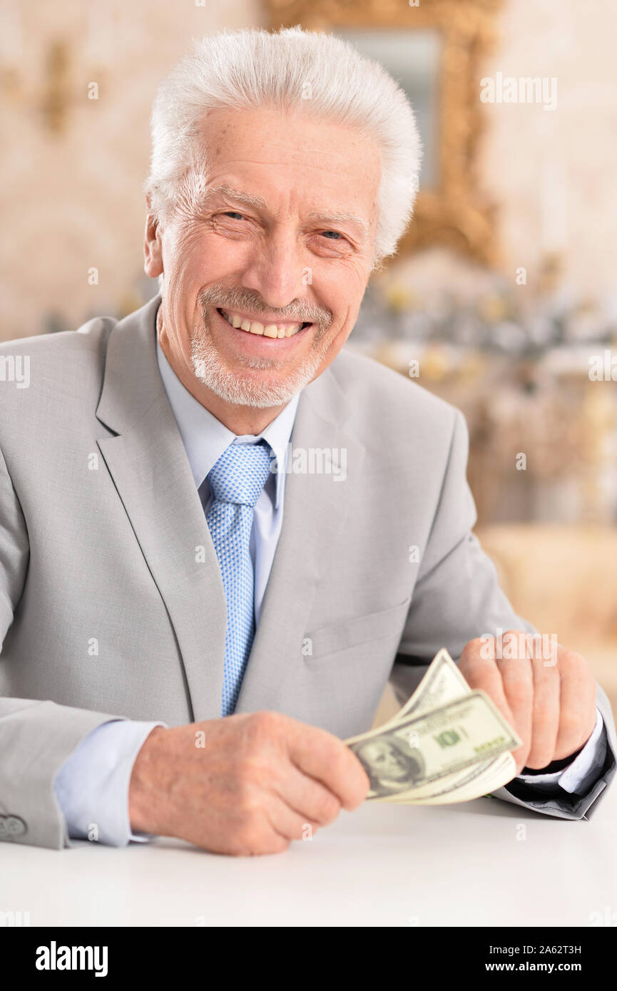 Portrait of a confident senior businessman counting money Stock Photo ...
