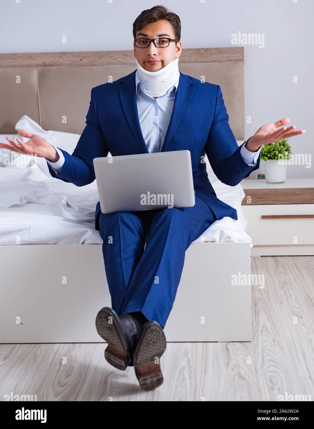 The businessman with neck injury working from home Stock Photo