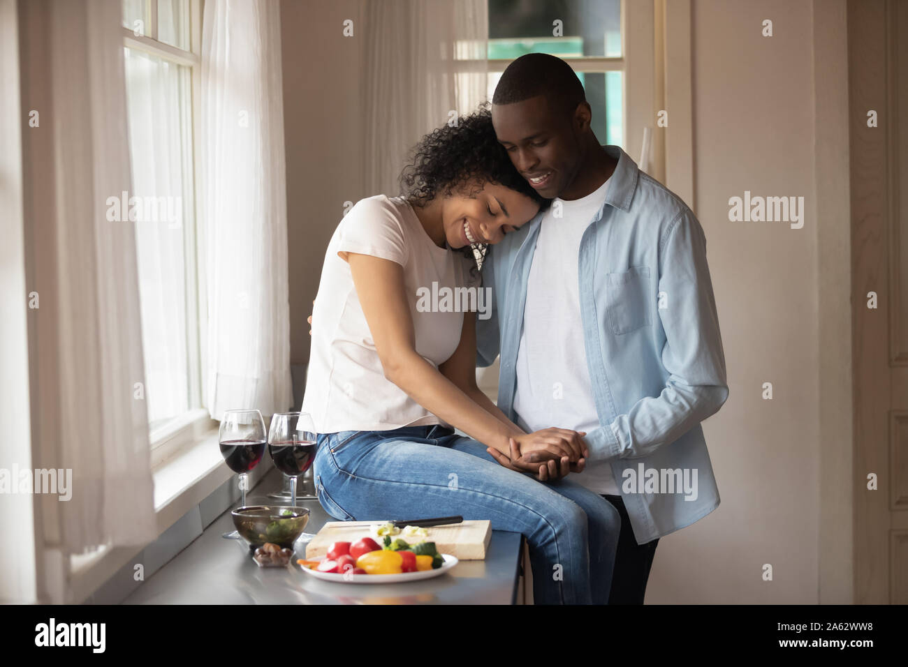 Happy millennial mixed race woman embracing smiling african american ...