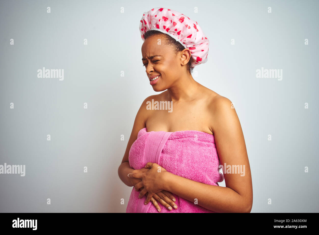 African american woman wearing pink shower towel after bath over