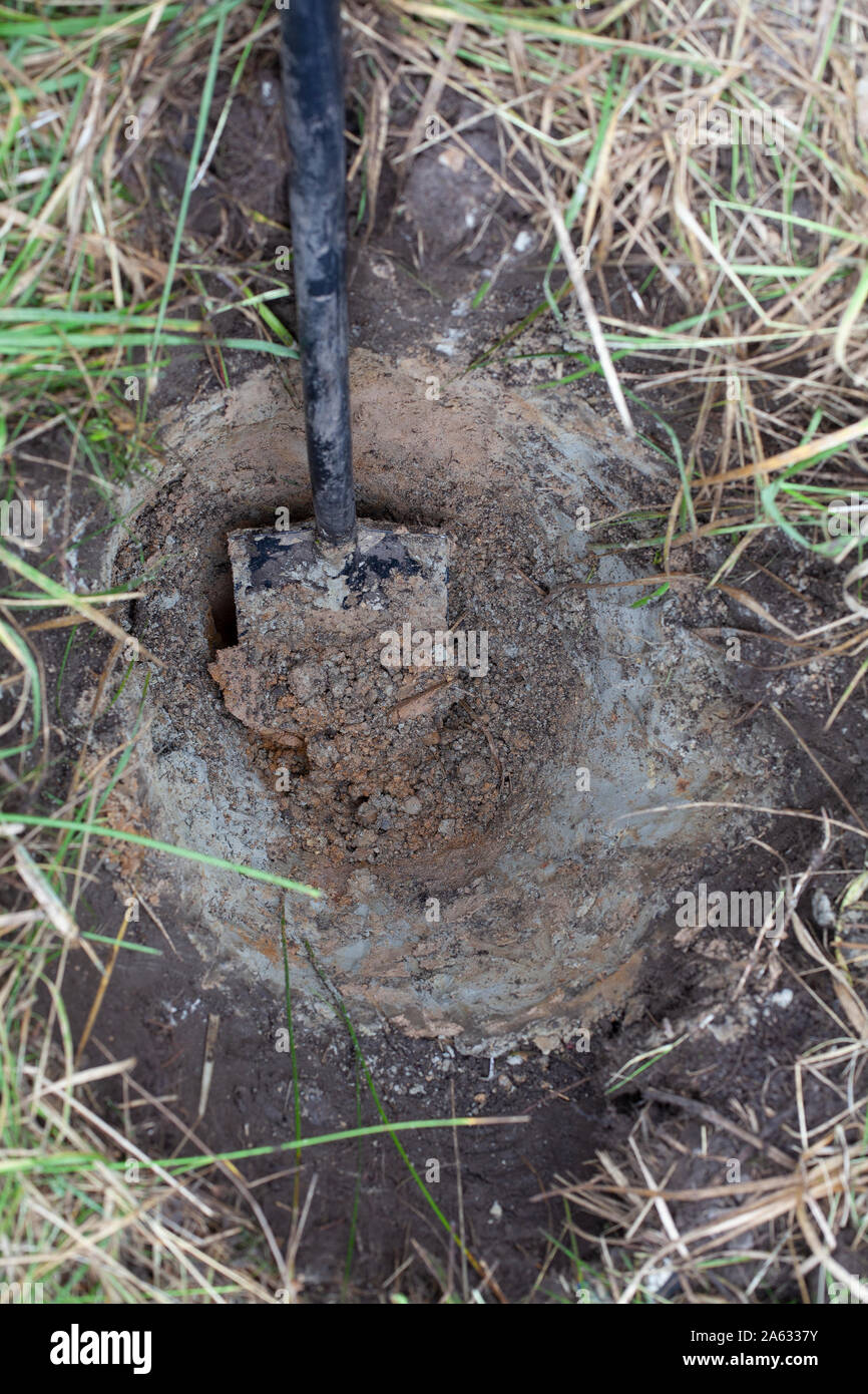 Digging a deep pit with shovel for replanting plants in a better soil Stock Photo