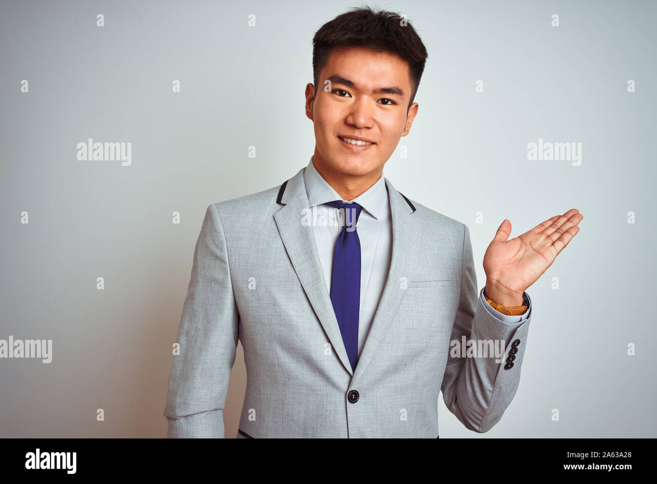 Asian chinese businessman wearing suit and tie standing over isolated ...