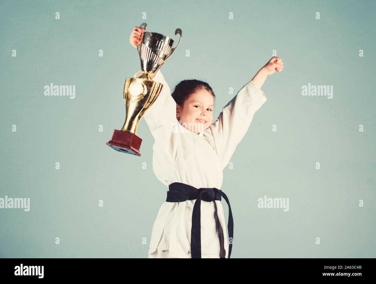 sport success. Training to be the best. small girl with champion cup