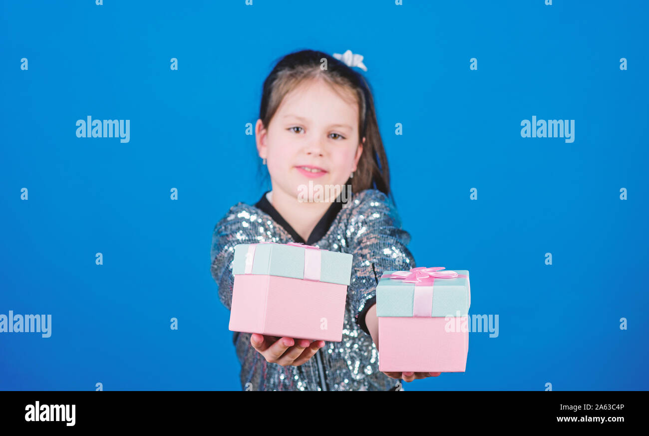 Black friday. Shopping day. Cute child carry gift boxes. Surprise gift box. Birthday wish list. World of happiness. Special happens every day. Choose one. Girl with gift boxes blue background. Stock Photo