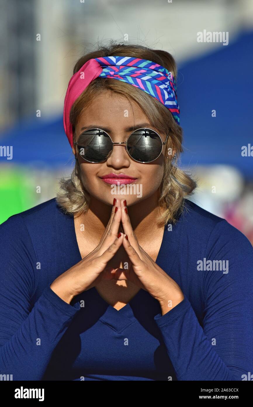 Hispanic Woman And Meditation Wearing Sunglasses Stock Photo