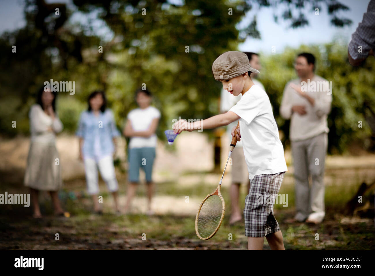Young boy playing badminton outdoors. Stock Photo