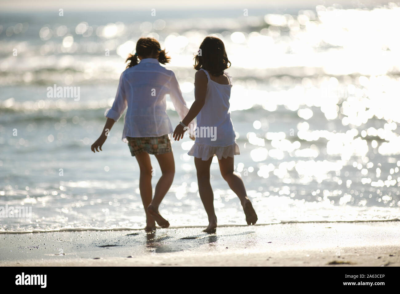 Two sisters on the beach Stock Photo - Alamy