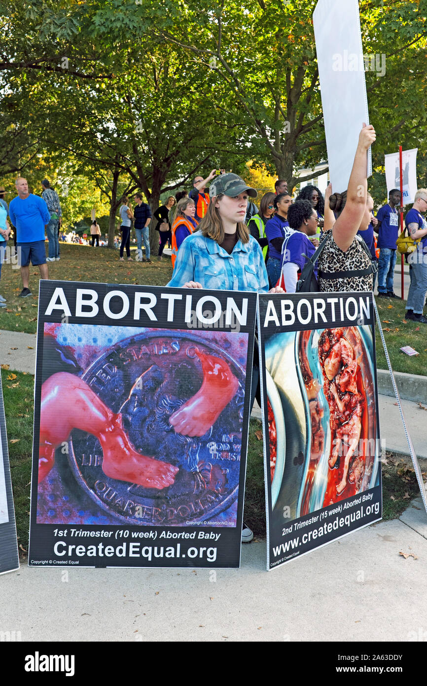 Anti-abortion demonstrators hold controversial signs during a political rally on Otterbein University campus in Westerville, Ohio, USA. Stock Photo