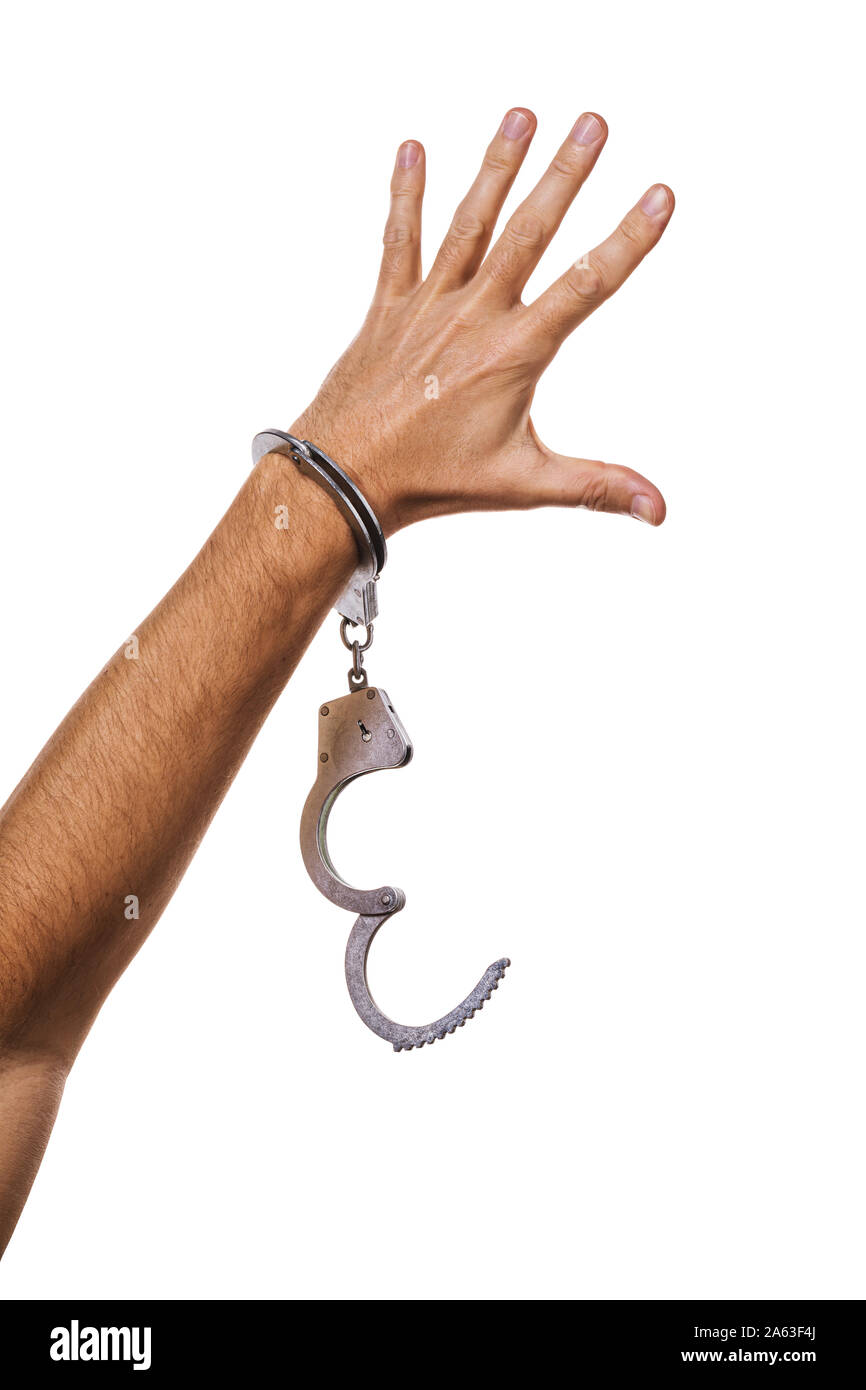 Concept on the theme of freedom. Mans hand in handcuffs isolated on white background Stock Photo