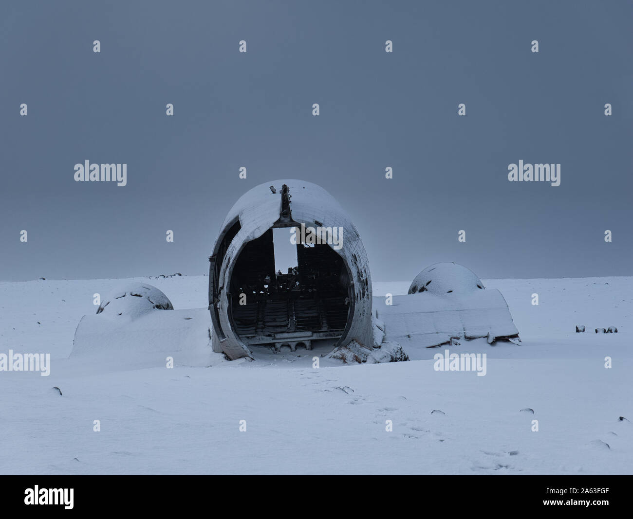 The tail of the plane wreck in Iceland in winter with fresh snow Stock Photo