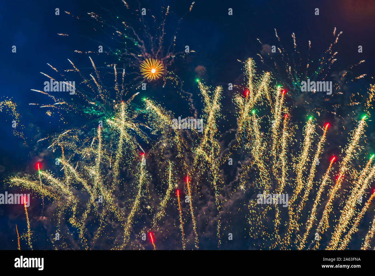 Inexpensive fireworks over the city sky, red, blue and white. Bright and shiny. Selective focus. For any purpose. Celebration concept. Stock Photo
