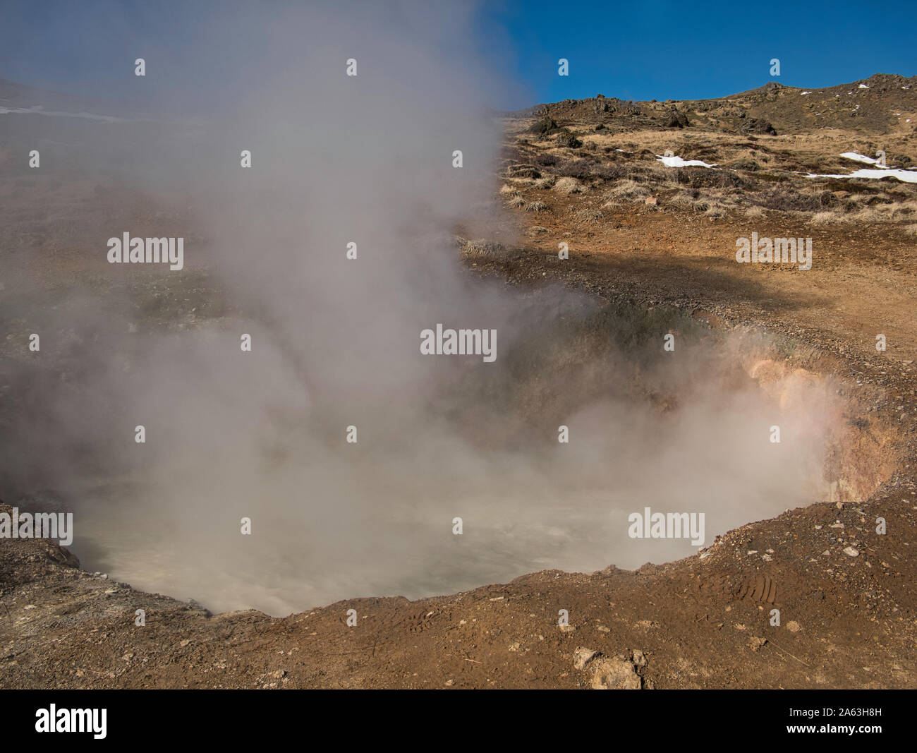 A bubbling mud pot in the mountains of Iceland Stock Photo
