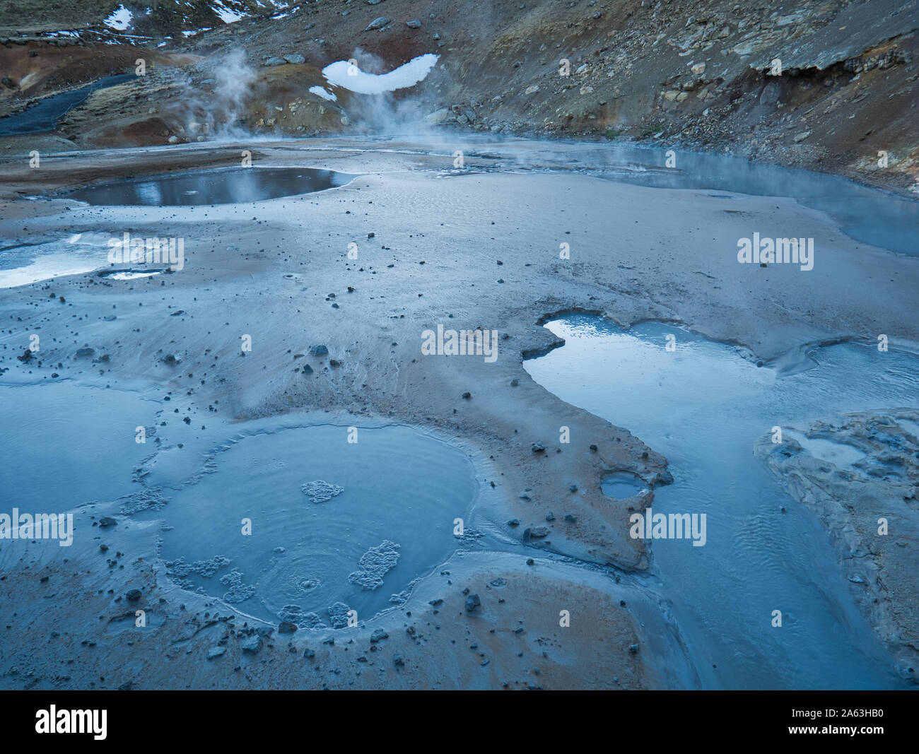 Mud hole in active geothermal area of Iceland at dusk Stock Photo