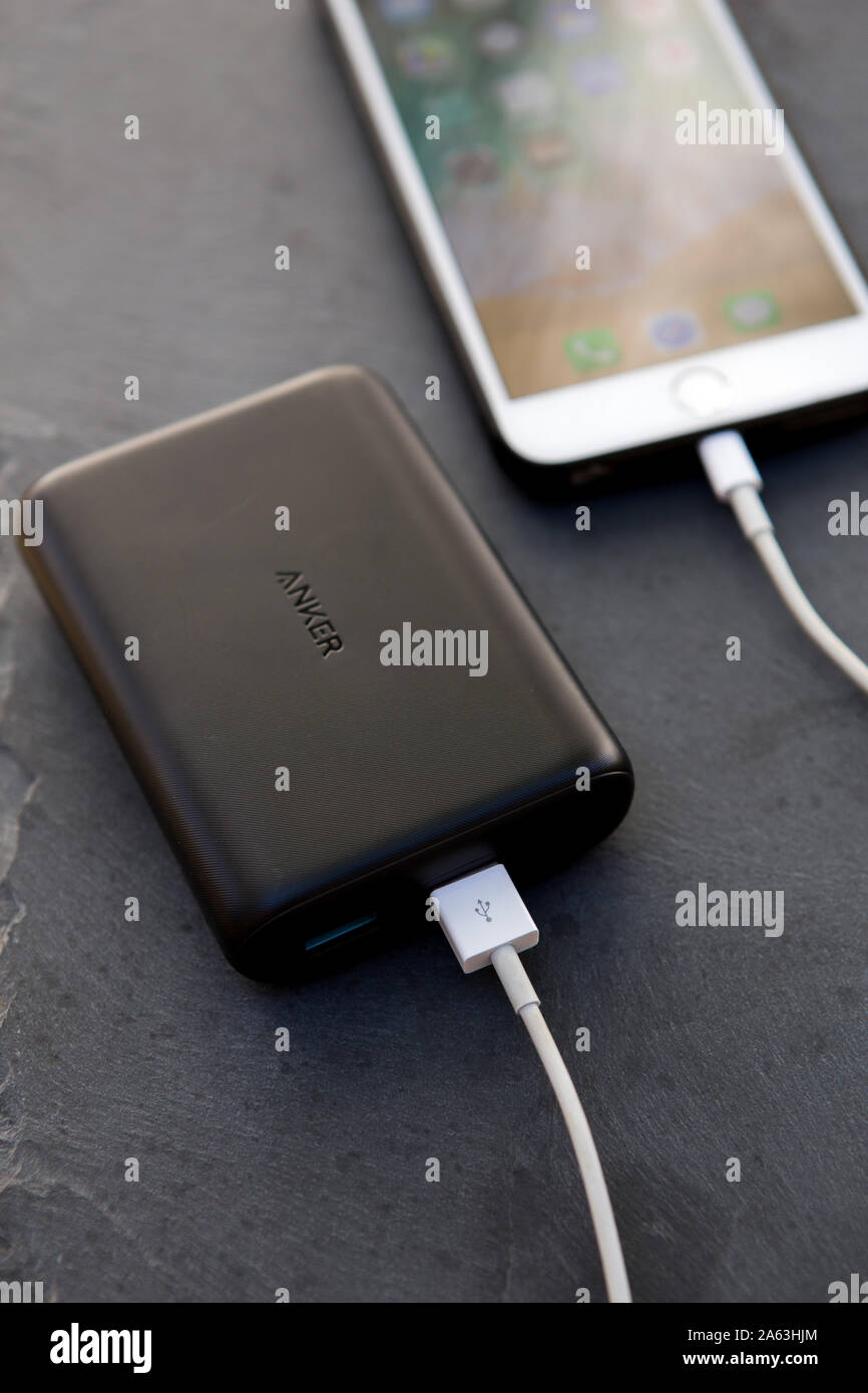 Anker power core15000 Redux portable power bank connected to and recharging  an iPhone 6 plus Stock Photo - Alamy