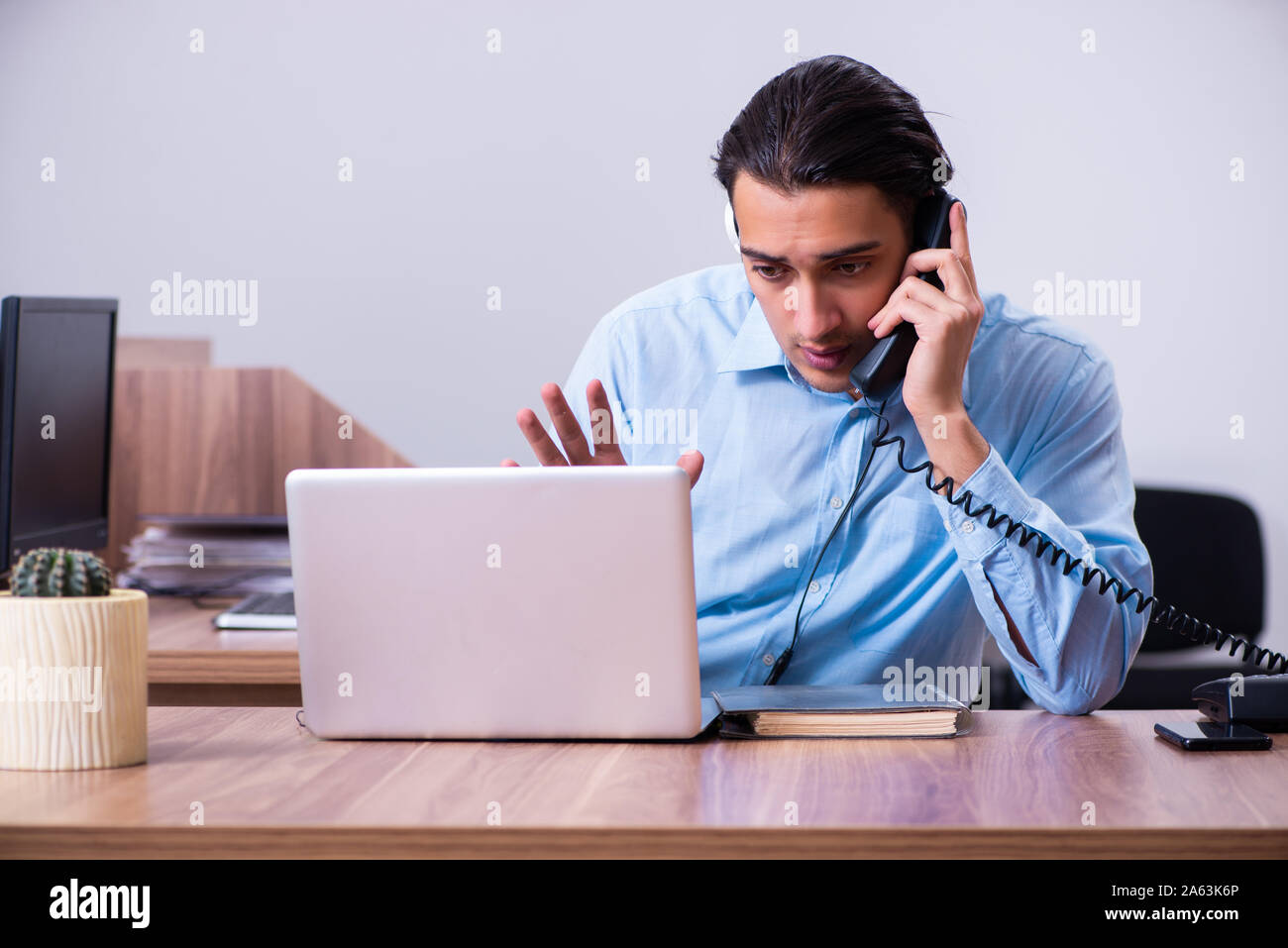 The call center operator working at his desk Stock Photo - Alamy