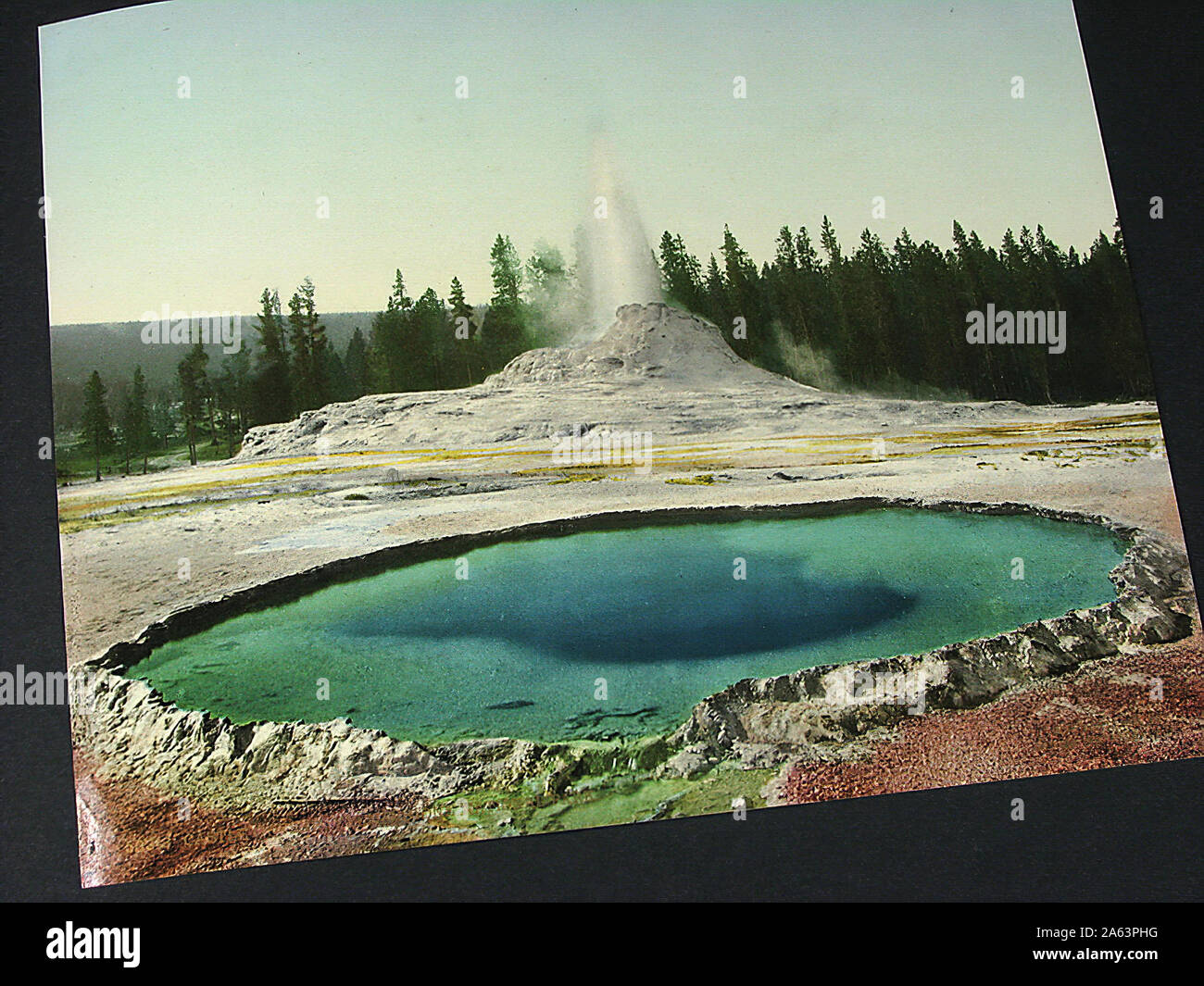 Nice and vintage album containing early Photochrom style colorized photographs of Yellowstone National Park. Stock Photo