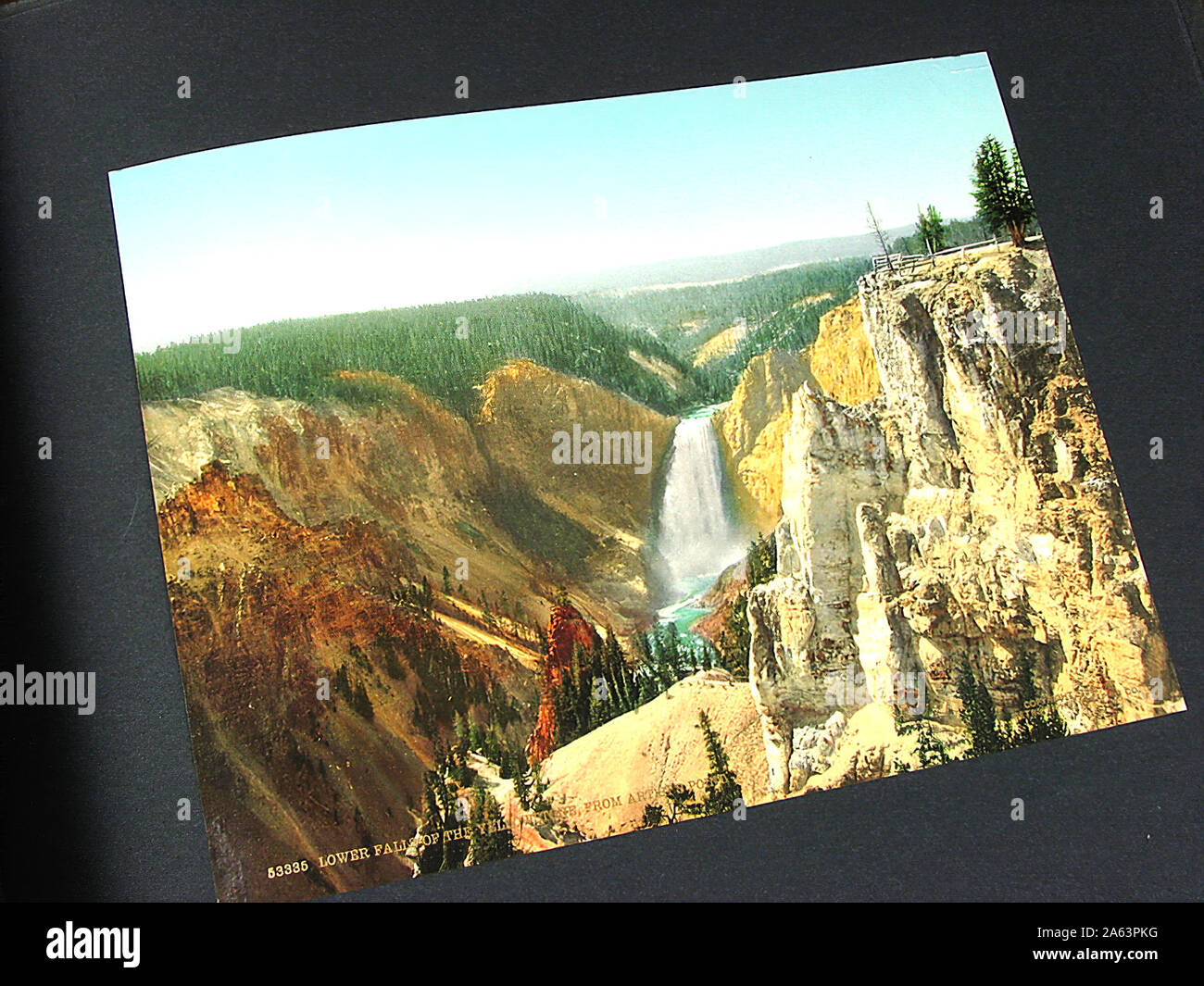 Nice and vintage album containing early Photochrom style colorized photographs of Yellowstone National Park. Stock Photo
