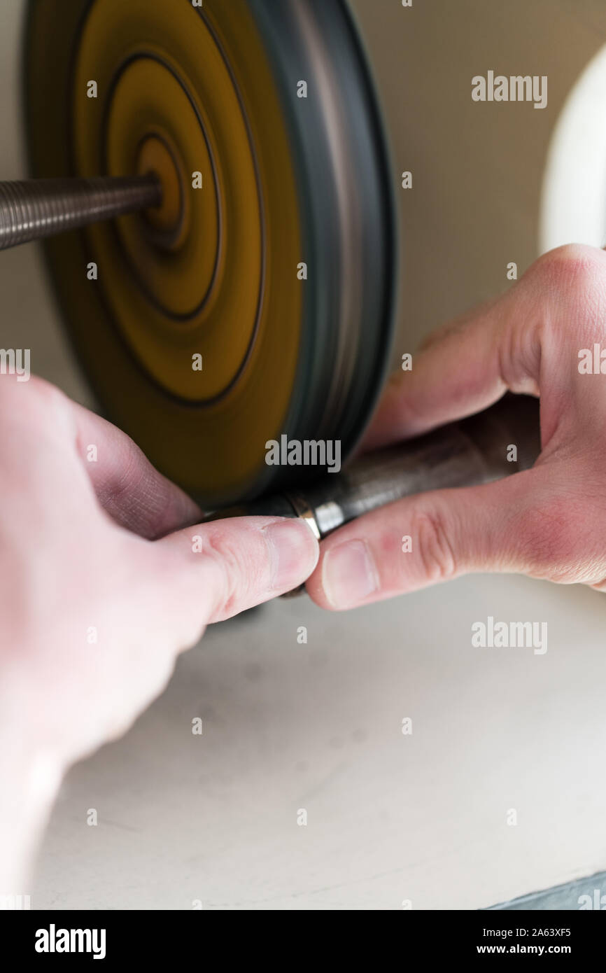 Jeweler Polishing A Gold Ring At Workbench Goldsmith Making A Ring At