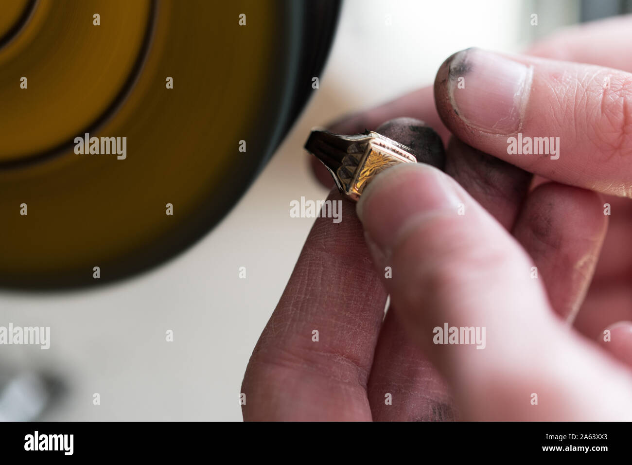 Jeweler Polishing A Gold Ring At Workbench Goldsmith Making A Ring At