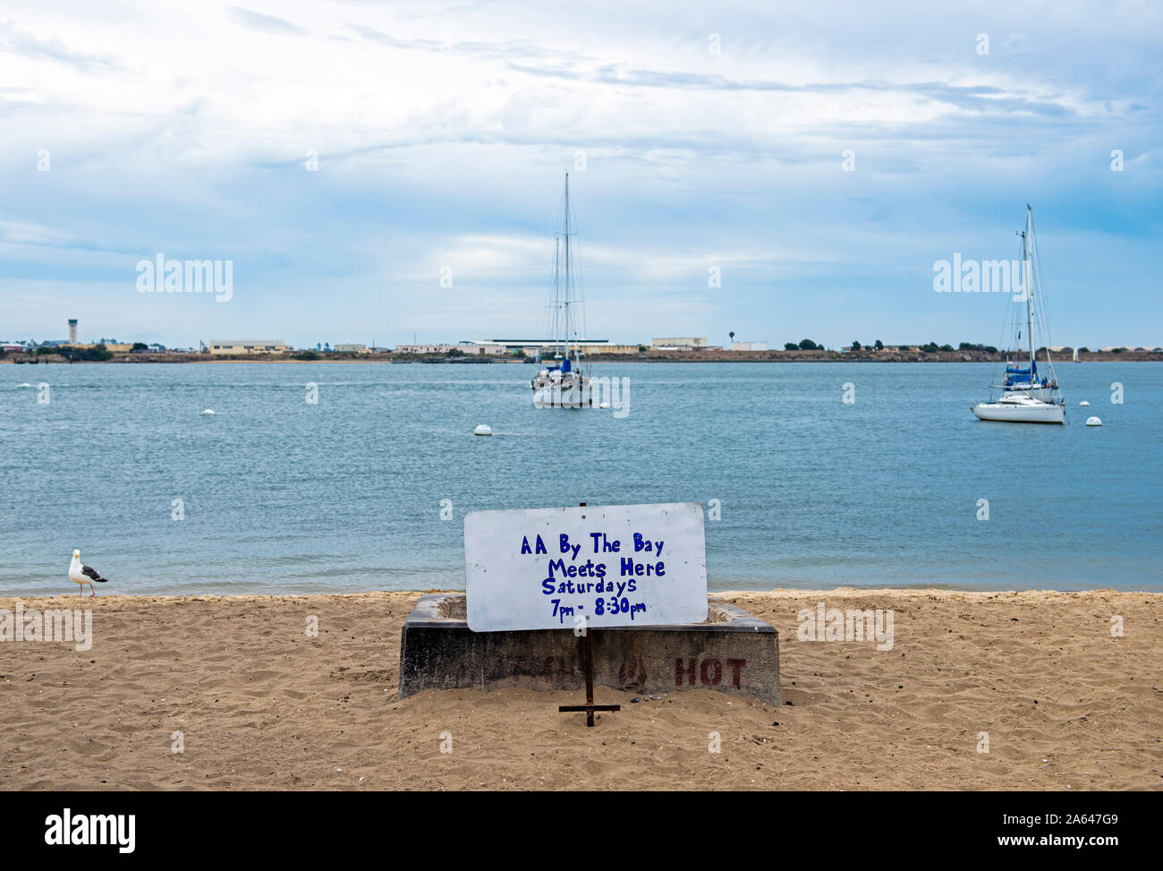 Sign posted on beach, in front of sand fire pit, announcing Alcoholic Anonymous meetings, San Diego Bay, Shelter Island, San Diego, California Stock Photo