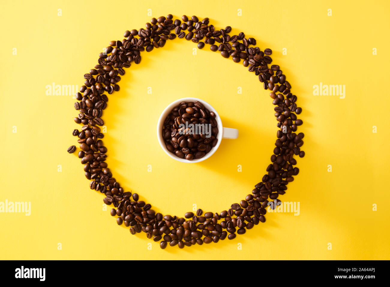 Cup of coffee in circle shape coffee beans on yellow background Stock ...
