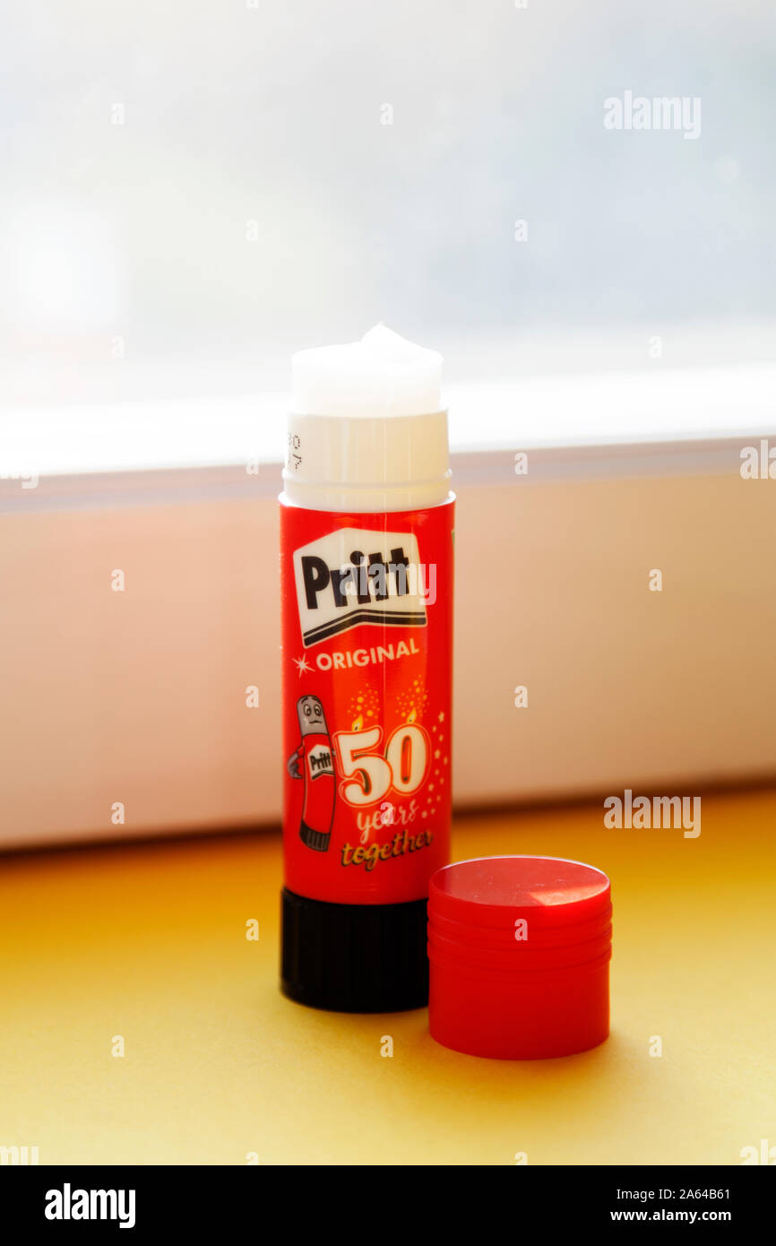 Pritt stick gum glue for paper held in a man's hand Stock Photo - Alamy