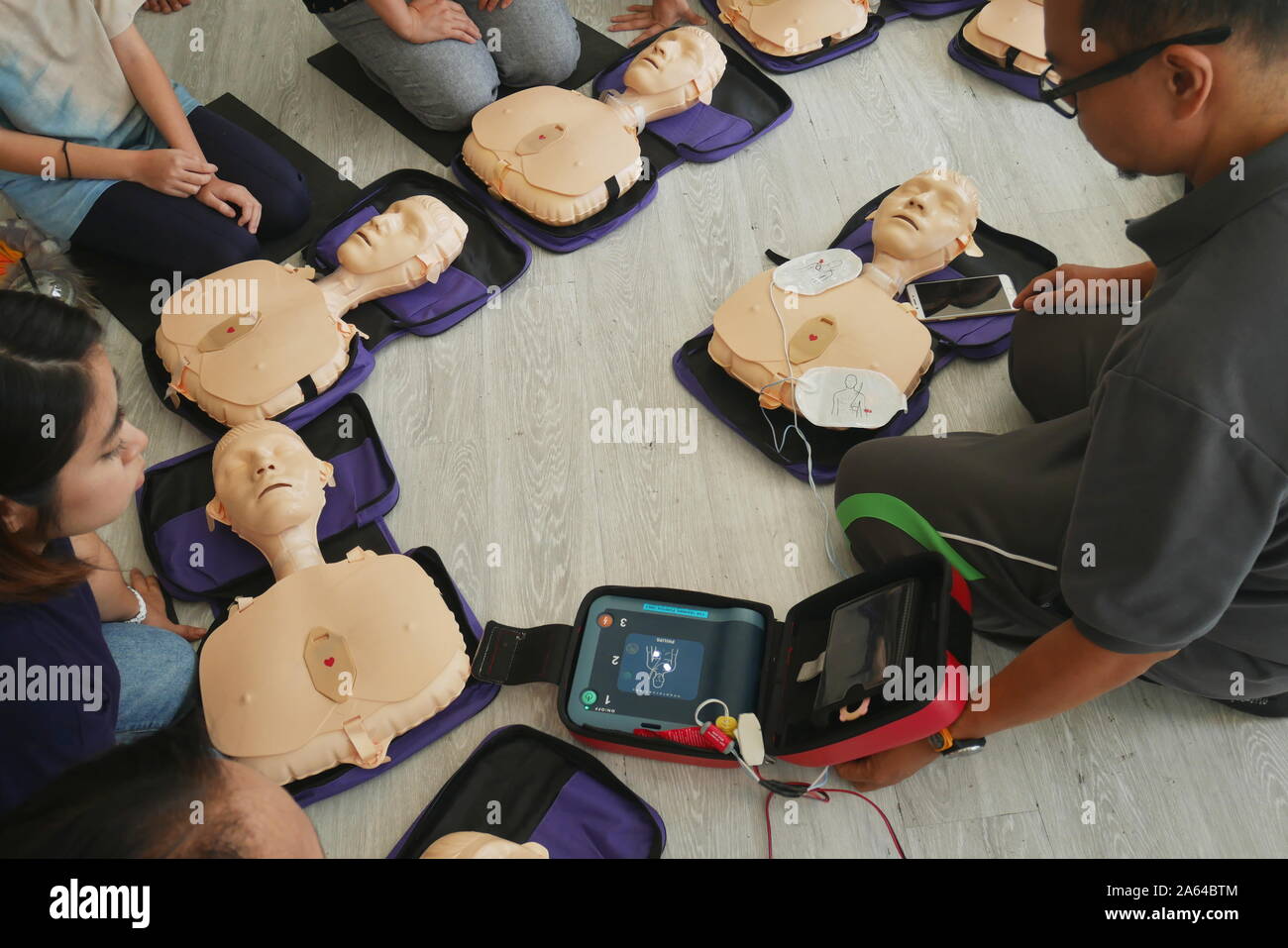 BANGKOK, THAILAND - OCTOBER 6, 2019 : a part of trainee , participant of CPR First Aid Training course using hand pump on chest of dummy for primary s Stock Photo