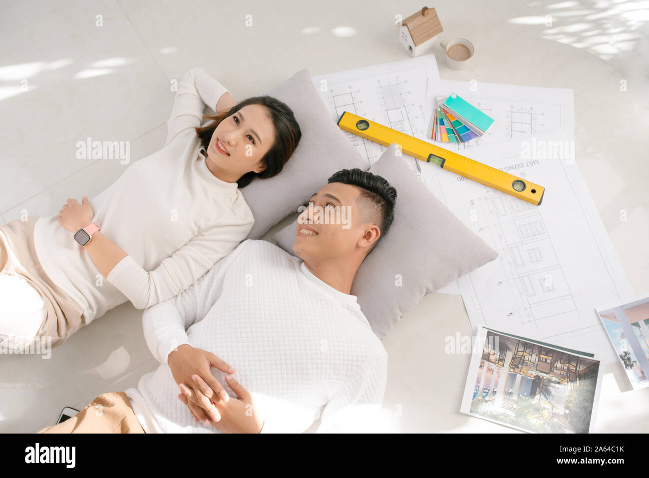 Portrait of happy cheerful couple looking at construction house plan Stock Photo